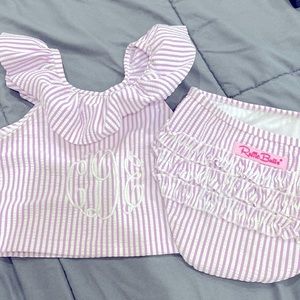 Ruffle Butts 2 piece swim suit. Purple seersucker with monogram “cDe” in white